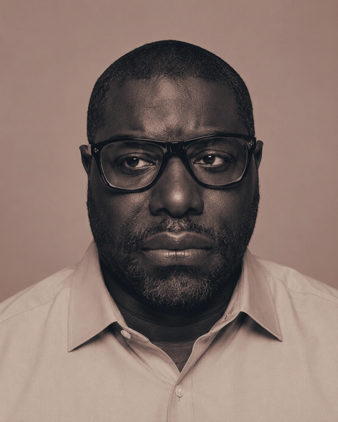 Editorial portrait of a man wearing glasses