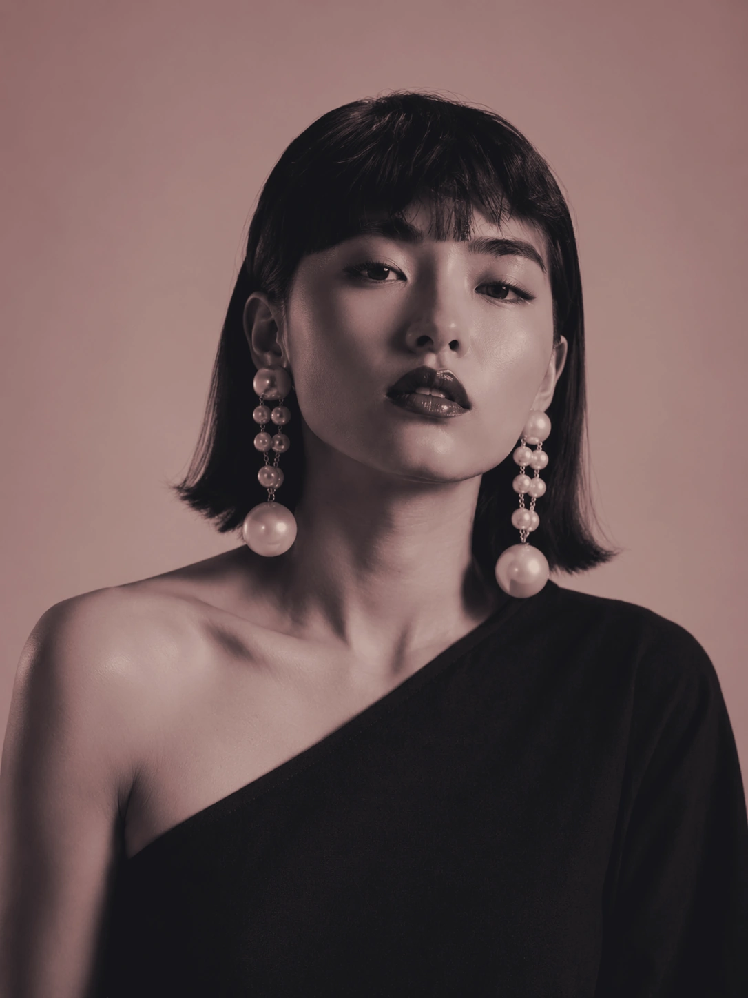 Editorial portrait of a woman wearing pearl earrings