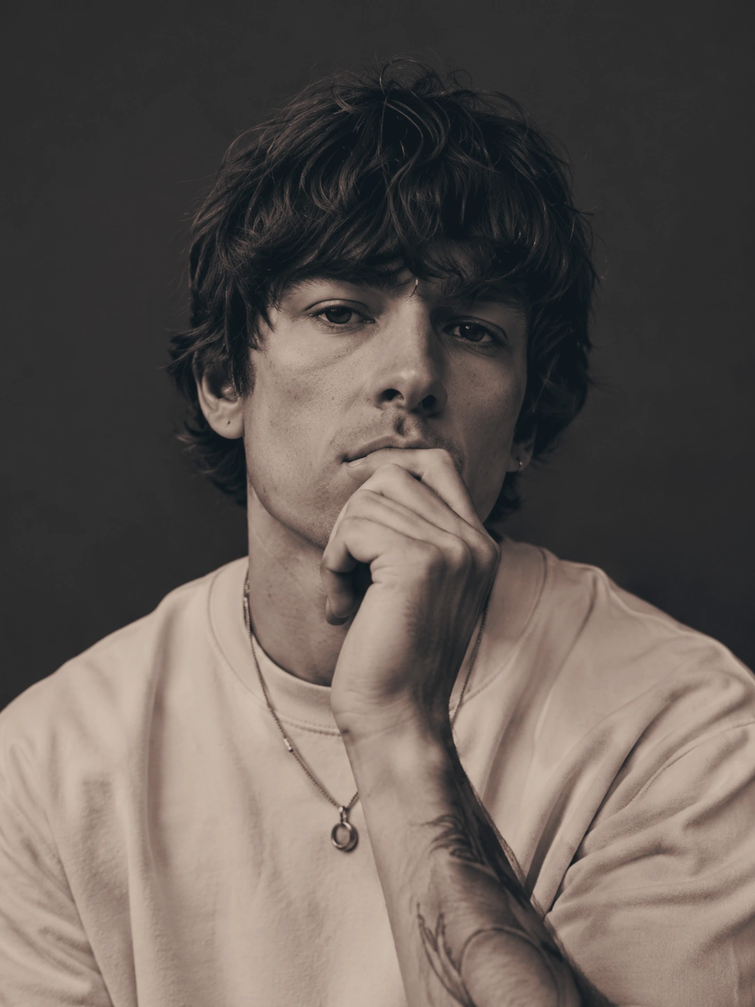 Editorial portrait of a man in a white shirt